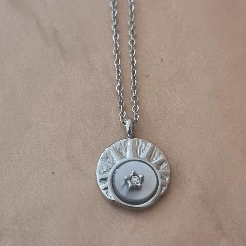 Détail du pendentif rond du collier HANNA Satine avec motif étoile